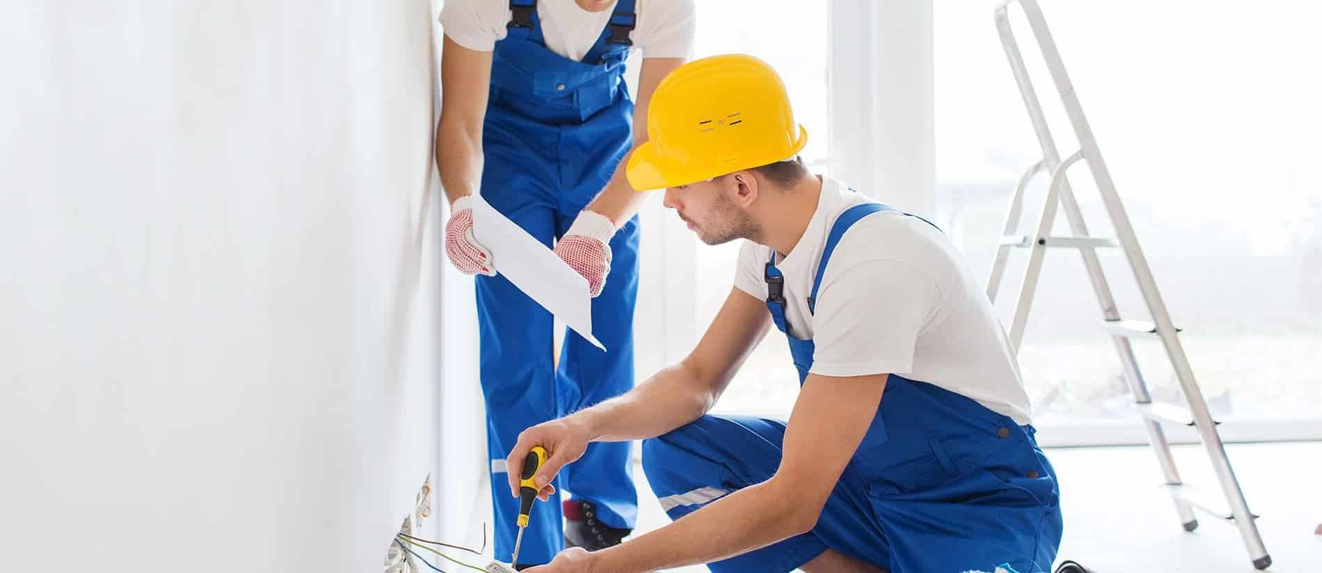 builders with tablet pc and equipment indoors